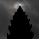 A partial solar eclipse is seen over the Independence Monument in Phnom Penh.